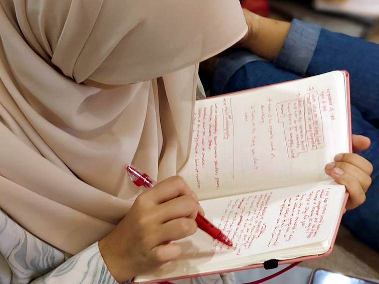 A participant writing in a notebook